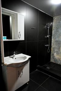 a bathroom with a white sink and a shower at StarHostel in Kutaisi