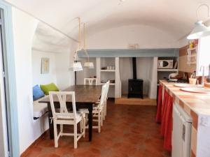 a kitchen and dining room with a table and chairs at Cueva Alfano in Freila