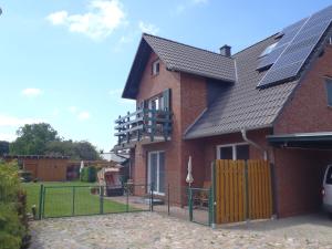 a brick house with solar panels on the roof at Weidenhof Zinnowitz in Zinnowitz