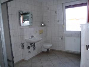 a bathroom with a sink and a toilet at Weidenhof Zinnowitz in Zinnowitz +3 photos