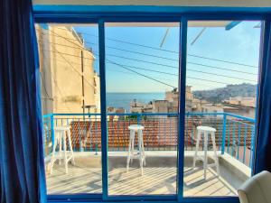 a view of the ocean from a balcony with stools at Island House Kavala in Kavála +40 photos