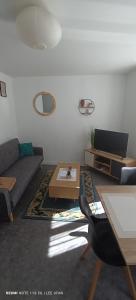 a living room with a couch and a table at T1 Bis - Centre Historique de Narbonne in Narbonne