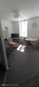 a room with a table and chairs and a television at T1 Bis - Centre Historique de Narbonne in Narbonne