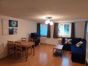 a living room with a table and a blue couch at Global Citizen 7 in St. Gallen
