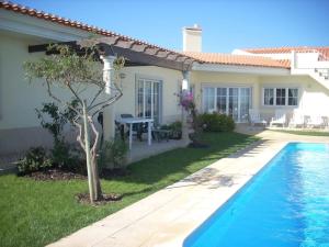 a villa with a swimming pool and a house at Luxury 6 Bedroom Oceanfront Vila - Sleeps 22 Guests in Foz do Arelho
