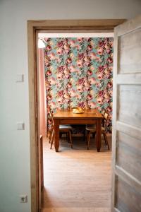 a dining room with a table and a floral wallpaper at Small Villa Subbi! in Tartu