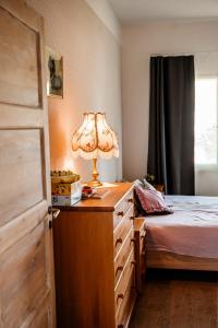 a bedroom with a bed and a lamp on a dresser at Small Villa Subbi! in Tartu