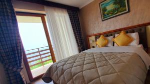 Postel nebo postele na pokoji v ubytování Hotel Panorama Dajt