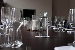 a table with wine glasses and a bottle on it at Lace Market Hotel in Nottingham +32 photos