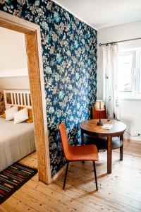 a bedroom with a bed and a desk and a table at Small Villa Subbi! in Tartu
