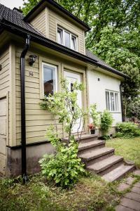 a small house with stairs leading up to it at Small Villa Subbi! in Tartu