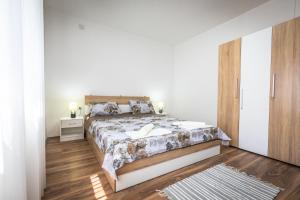 a bedroom with a large bed and a wooden floor at Vila Elena in Gevgelija