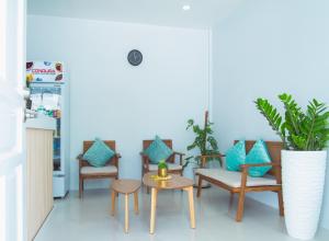 a room with chairs and a table with blue pillows at Tropical Stay Accommodations Dao in Tagbilaran City