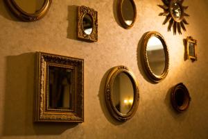 a wall with mirrors and frames on a wall at Dukes Hotel Hakata in Fukuoka