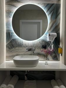 a bathroom with a sink and a mirror at Plaża Resort Łeba & Wellness in Łeba +24 photos