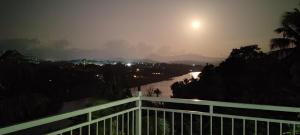 a view of a river from a balcony at night at Mahaweli View Inn in Kandy