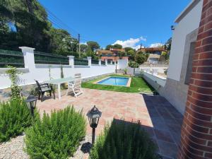 a patio with a table and chairs and a pool at Villa Lloret de Mar 6 Personas in Vidreres