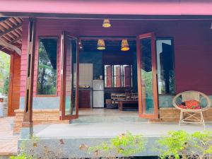 a porch of a house with a table and a chair at soi one house in Pai