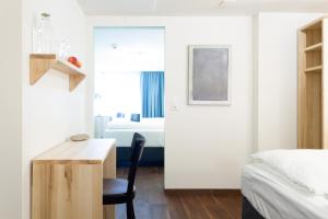 - une chambre avec un lit, un bureau et un lit dans l'établissement Hotel Schlüssel, à Lucerne