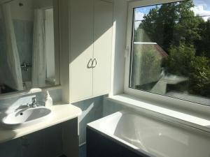 a bathroom with a sink and a window at Jūrlejas in Kaltene +58 photos
