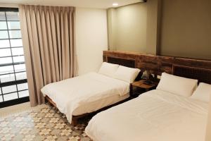 Postel nebo postele na pokoji v ubytování 莊同益民宿 Zhuang Tongyi Homestay