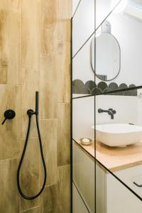 a bathroom with a shower and a sink at S11 Apartman in Debrecen
