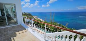 a balcony with a view of the ocean at Villa Hafa in Tangier