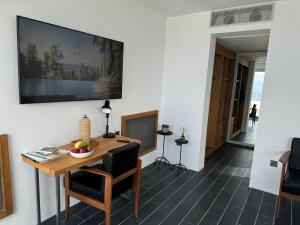 a room with a table and chairs and a television on the wall at Villa Hafa in Tangier