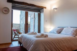 Postel nebo postele na pokoji v ubytování CASAS DA MORGADINHA - Casas de Férias e Turismo Rural