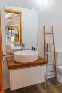 a bathroom with a sink and a mirror at CASAS DA MORGADINHA - Casas de Férias e Turismo Rural in Celorico de Basto