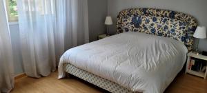 a bedroom with a bed with a blue and white headboard at Vue Mer Capitou in Mandelieu-la-Napoule +15 photos