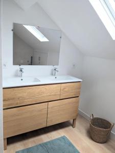 a bathroom with a sink and a mirror at La balme St Jo, vue, calme et piscine 6 chambres in Mûres-les Balmettes