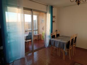 a dining room with a table and a balcony at Bellevue in Six-Fours-les-Plages +19 photos