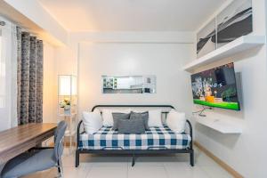 a living room with a couch and a table at Camella Northpoint I 2 Bedroom I 3 mins to Abreeza Mall in Davao City