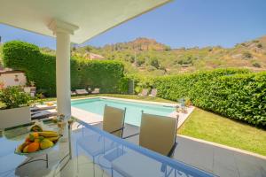 a view of the pool from the balcony of a villa at Villa Almond in Taormina