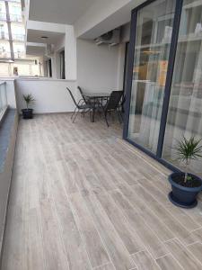 an empty patio with chairs and a table on a building at DelEric apartments in Eforie Nord