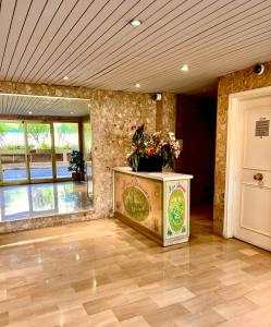 a room with a table with a vase of flowers on it at Luxury Penthouse near the Beach in Antibes +23 photos