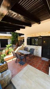 a patio with a table and chairs on a patio at Your Afytos Home in Afitos
