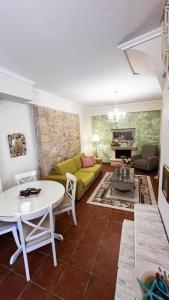 a living room with a yellow couch and a table at Your Afytos Home in Afitos