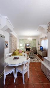 a living room with a white table and chairs at Your Afytos Home in Afitos +22 photos