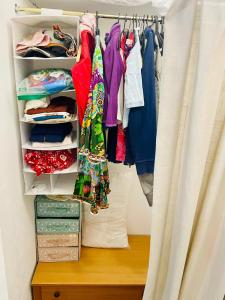 a closet filled with lots of clothes and a curtain at Casina di Adele apartment in Volterra +33 photos