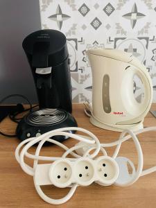 a coffee maker and a toaster on a table at Logis sympa proche des thermes in Saint-Pierre-dʼAllevard