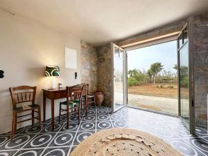 a living room with a table and chairs and a sliding glass door at Μονοπάτι in Agia Anna Naxos