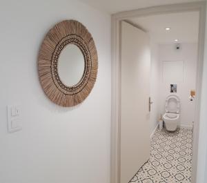 a bathroom with a mirror and a toilet at Le pommier in Aiglun +24 photos