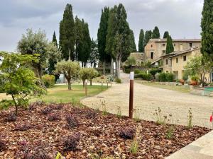 a garden with a sign in the middle of a dirt road at Casina di Adele apartment in Volterra
