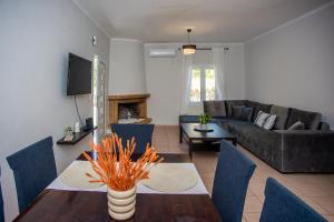 a living room with a couch and a table at Erasmia's house in Lakíthra