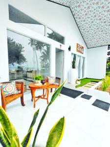 a patio with a table and chairs on it at Stella Villa in Ngurblut