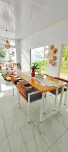a dining room with a wooden table and benches at Stella Villa in Ngurblut +7 photos