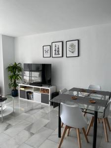 a living room with a table and a tv at Kandy Apartment in Mijas