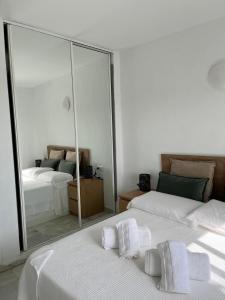 a bedroom with two beds and a large mirror at Kandy Apartment in Mijas Costa +4 photos